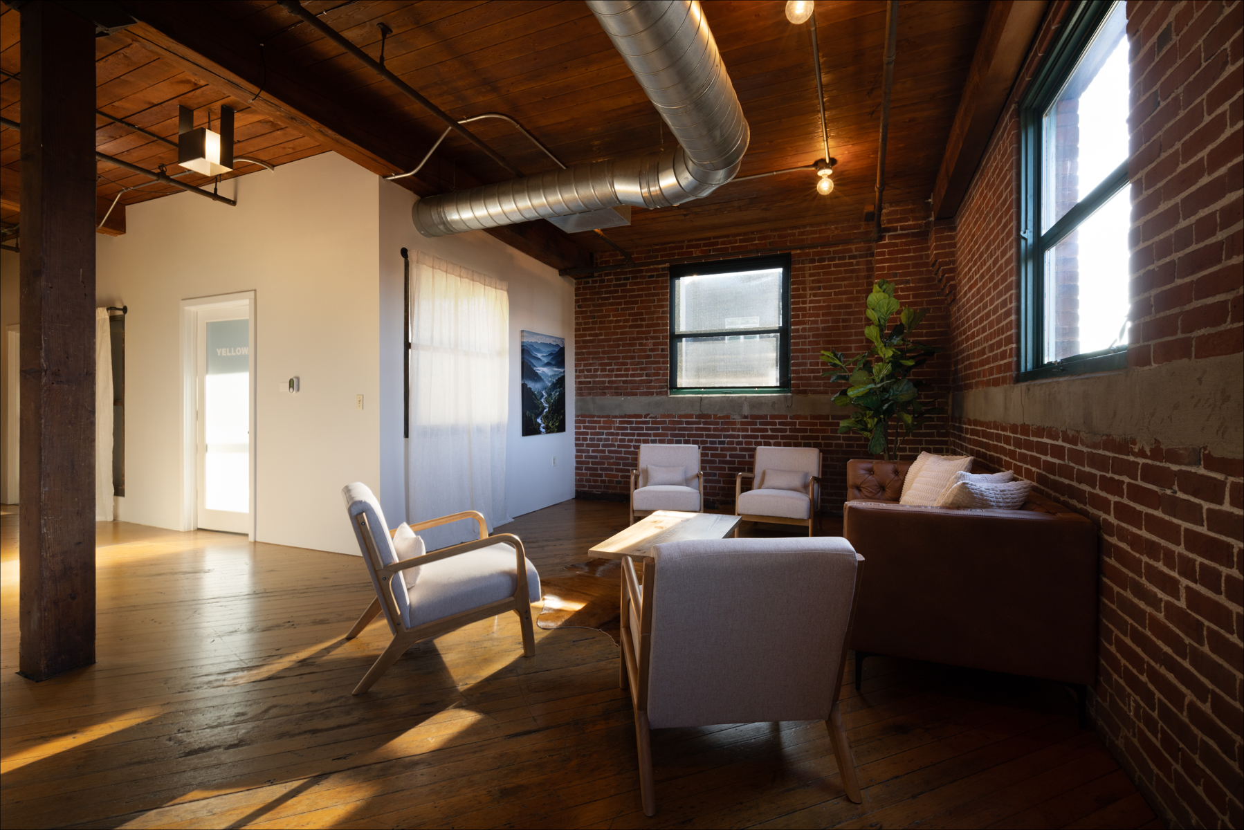 Individual Experience 4 Cozy retreat space featuring modern seating, wooden floors, and natural light, designed for women's healing and personal growth at Experience Onward.